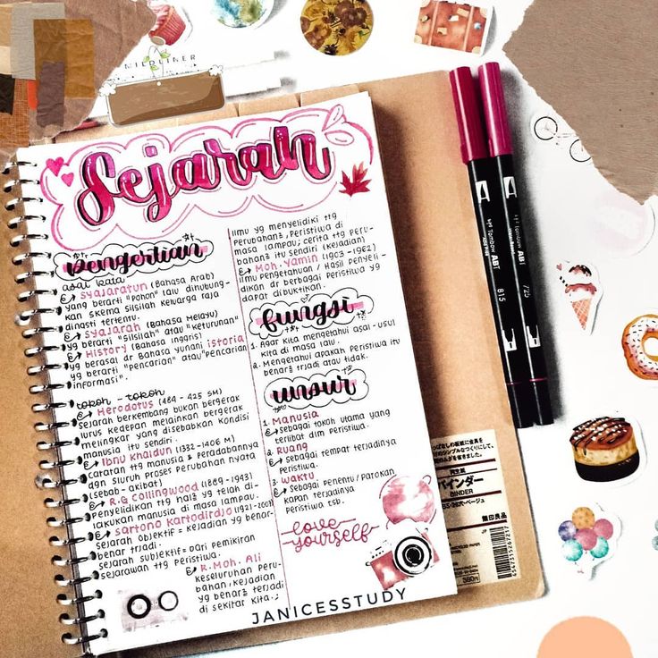 a spiral notebook with writing on it next to some stickers and other items that include pens