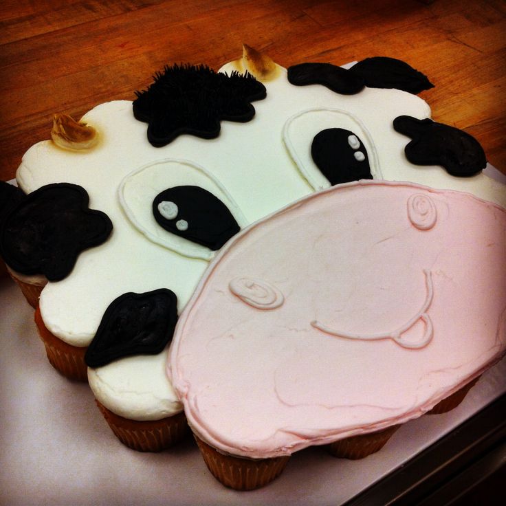 there is a cake shaped like a cow with black and white frosting on it