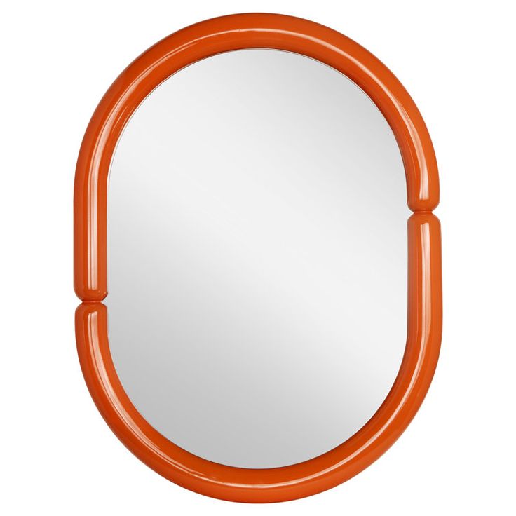 an orange round mirror on a white wall