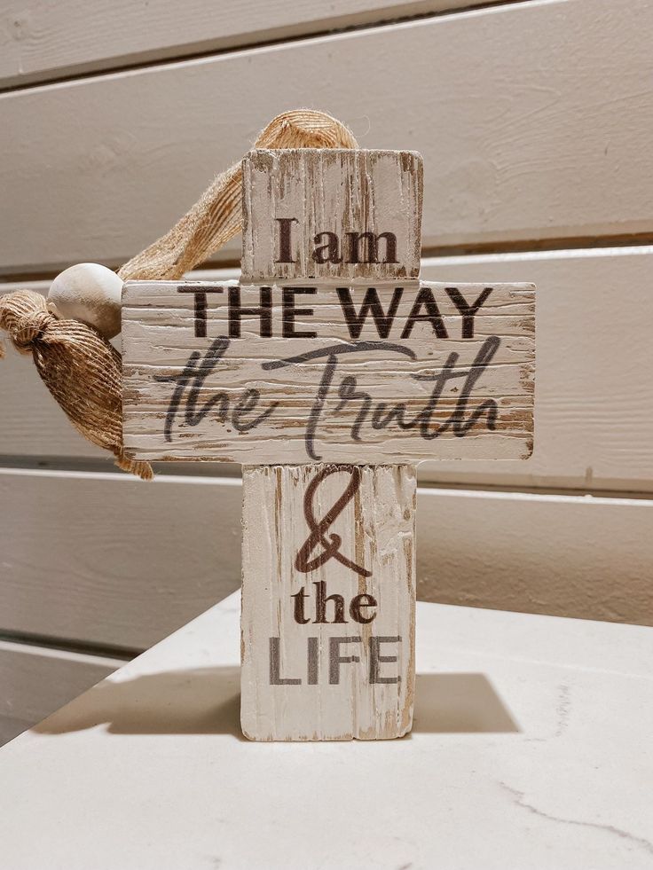 a wooden cross with the words i am the way, the truth and the life on it