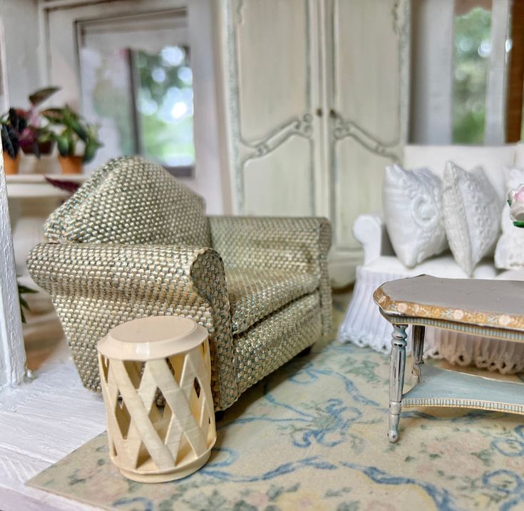 a living room filled with furniture next to a white couch and table on top of a rug