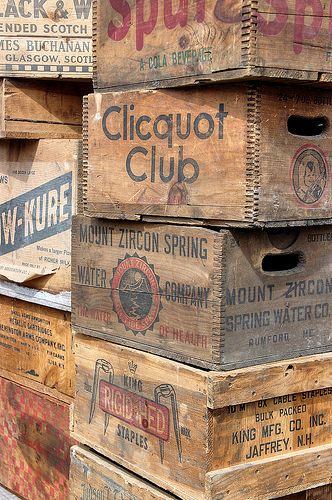 several wooden crates stacked on top of each other with different types of labels in them