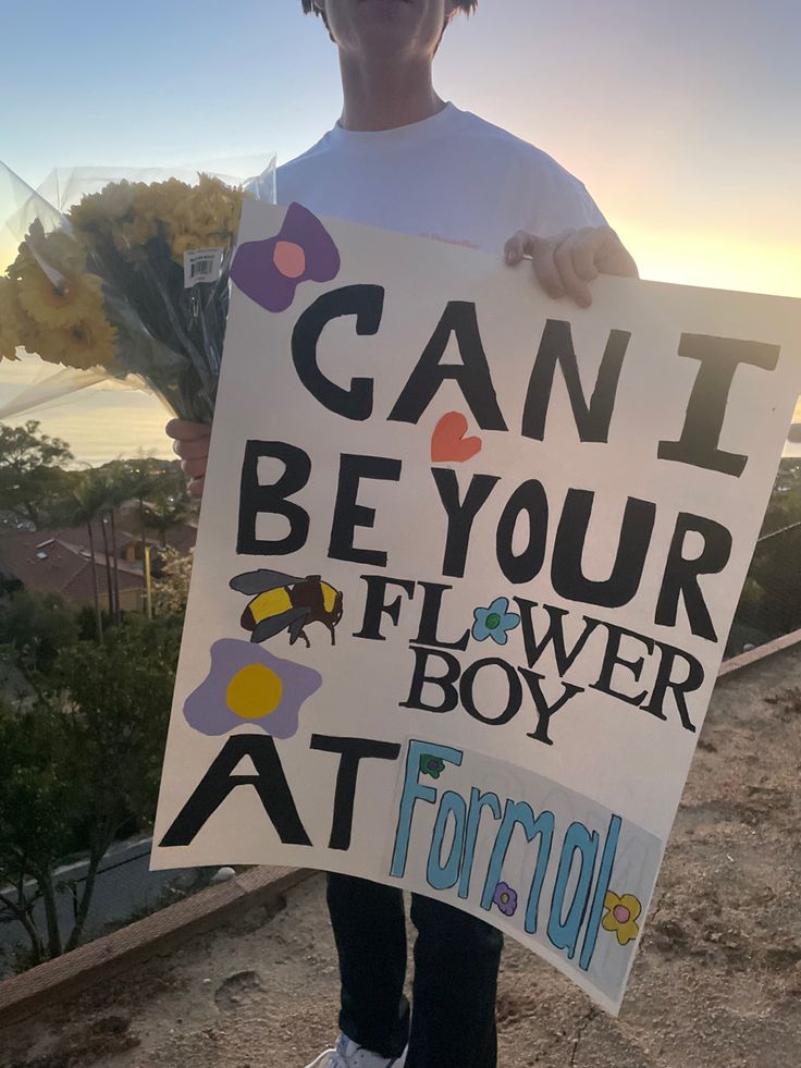 a person holding a sign that says can't be your flower boy