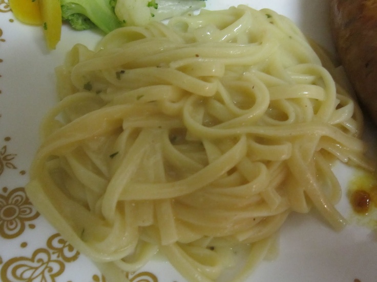 some noodles and broccoli are on a plate