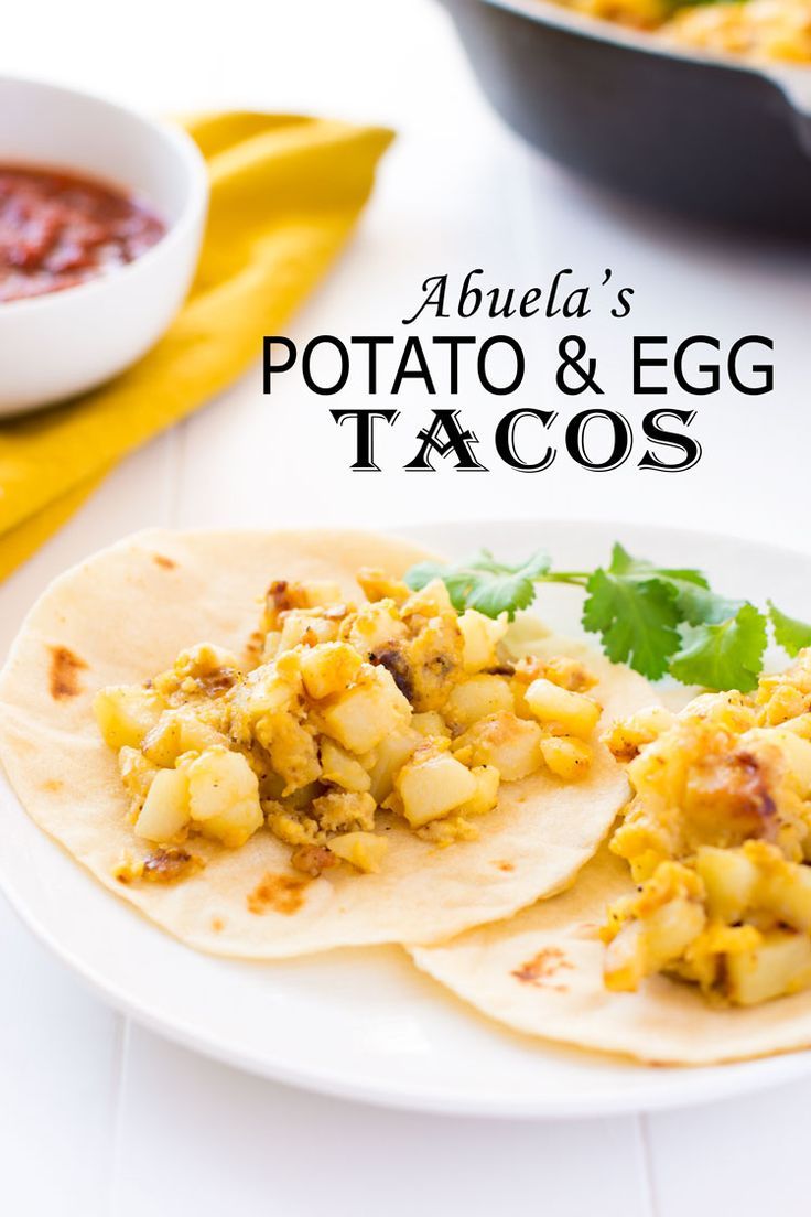 two tortillas on a plate with salsa in the background and text overlay reading abuela's potato & egg tacos