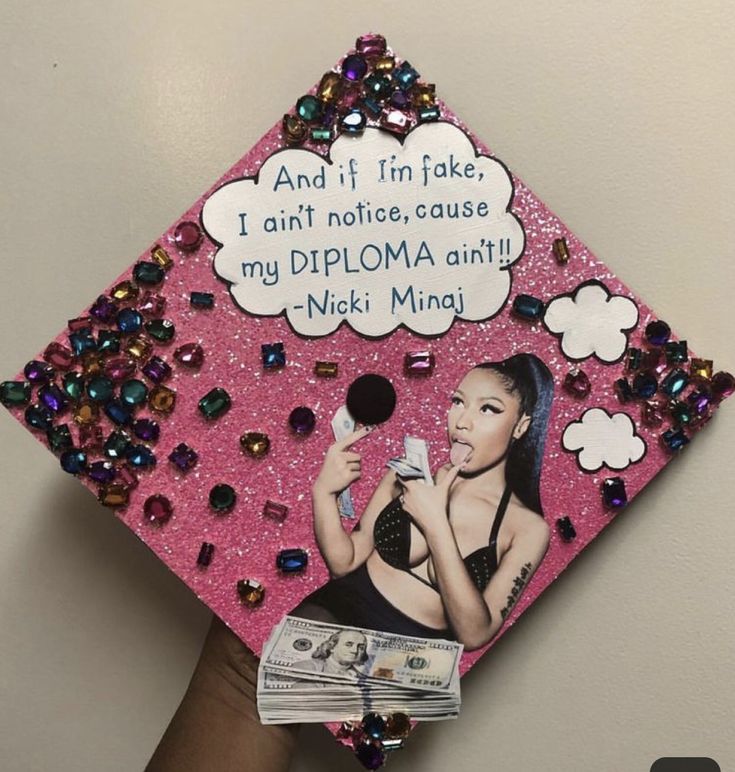 a pink graduation cap decorated with an image of nicki mina