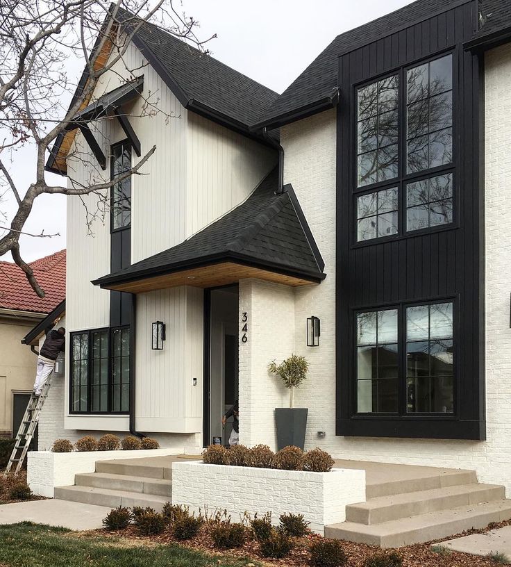 a white and black house with steps leading up to it