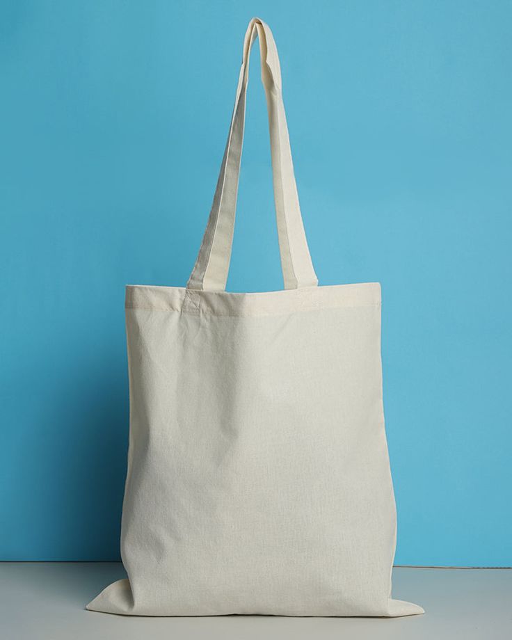 a white bag sitting on top of a table next to a blue wall and floor