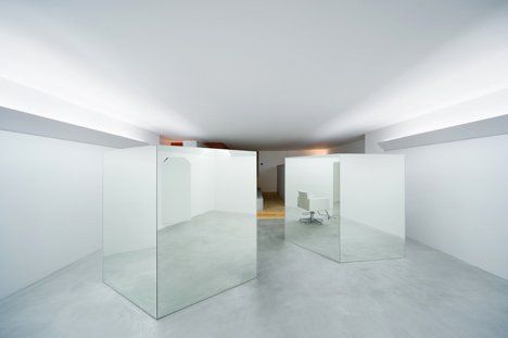 an empty room with white walls and glass partitions