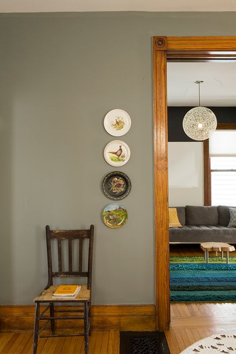 a living room filled with furniture and plates on the wall