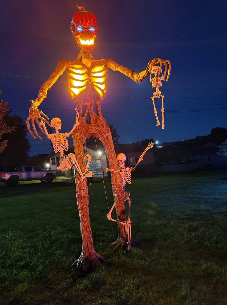 a lighted skeleton standing in the grass with two skeletons on it's legs and arms