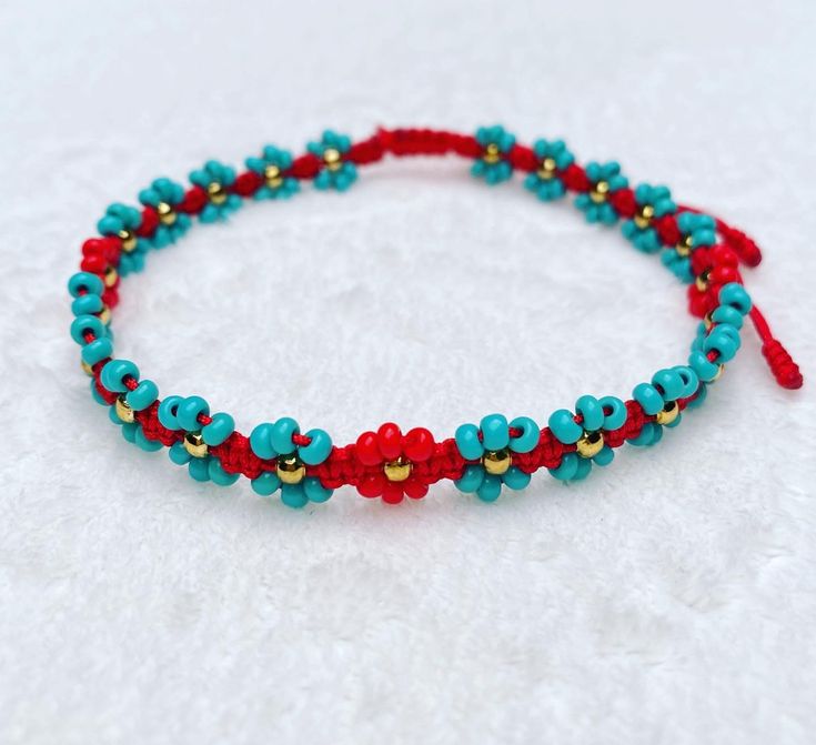 a red and blue beaded bracelet with hearts