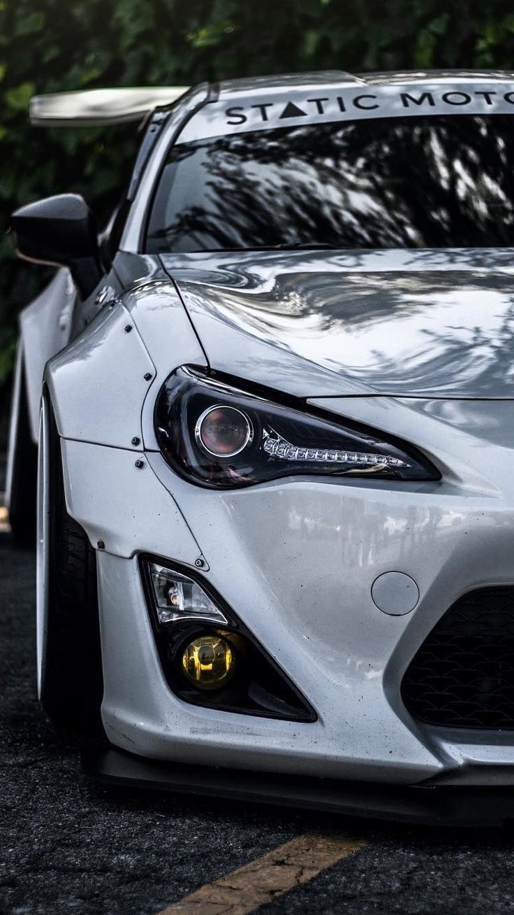 the front end of a white sports car