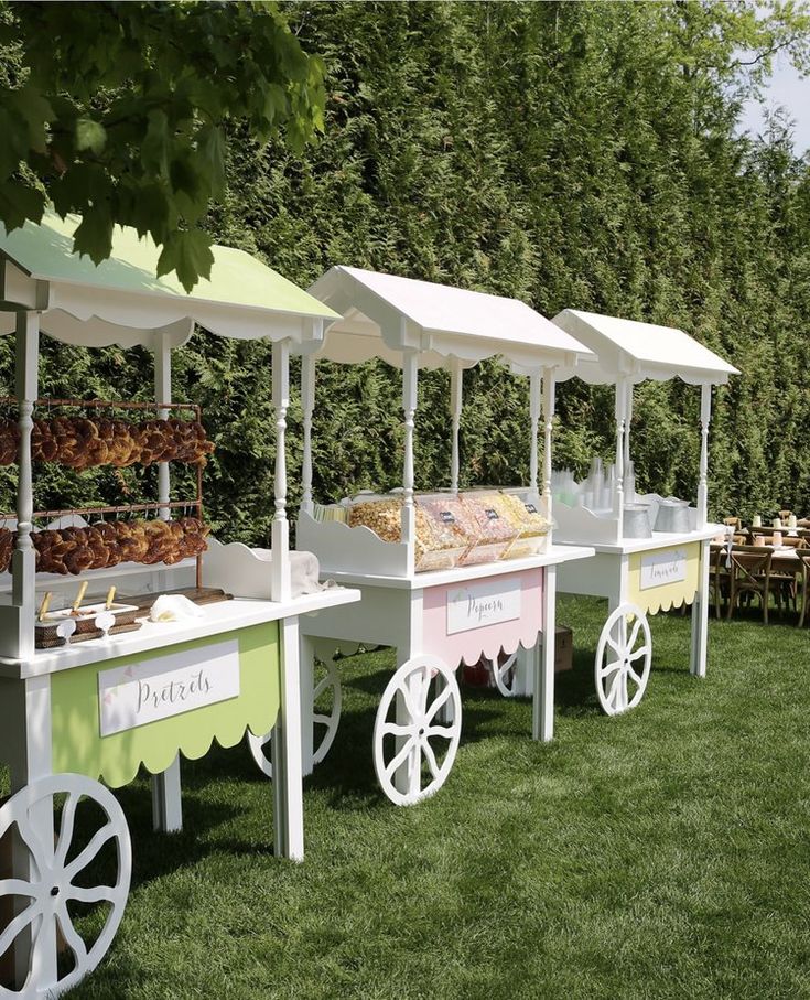 an assortment of pastries and desserts on display in the grass at a park