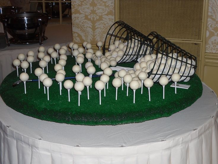 there are many white cake pops on the green tableclothed round trays that have been placed together