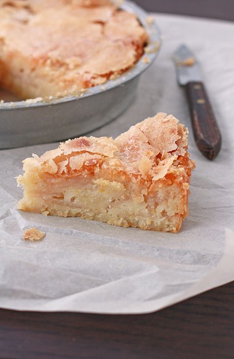 a piece of pie sitting on top of a pan next to a knife and fork