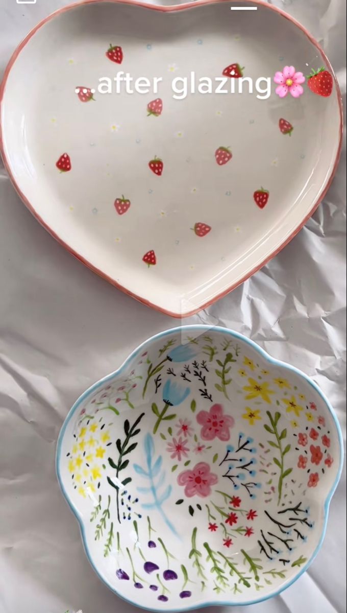 two heart shaped dishes sitting next to each other