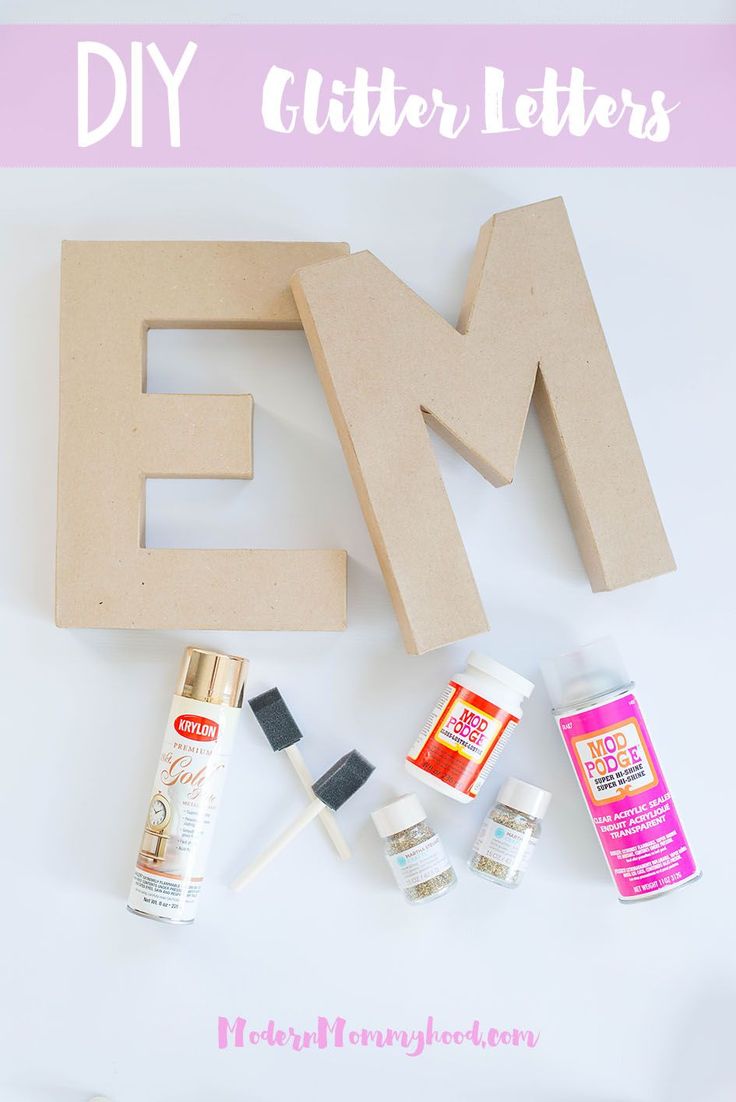 diy letter letters with glue, paint and other crafting supplies on top of it