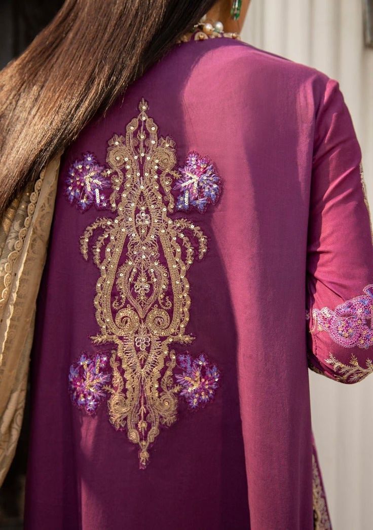 This expertly created Kashmiri tanka ethnic design with dijon and magenta sequins on a plum base surely makes a statement. The look is finished with dyed pants and a jacquard woven burnout dupatta. Shirt Front Centre Panel Embroidered On Dyed Lawn Shirt Side Kali Embroidered On Dyed Lawn (Right) Shirt Side Kali Embroidered On Dyed Lawn (Left) Shirt Daman Border Embroidered On Dyed Lawn Sleeves Embroidered On Lawn Sleeves Border On Dyed Lawn Sleeves Patti Embroidered On Dyed Lawn Back Plain Dyed Eid Dresses With Dabka Detailing, Embroidered Purple Silk Dress, Dabka Embroidered Dress For Wedding, Festive Silk Dress With Dabka Embroidery, Designer Wear Embroidered Dress With Dabka, Unstitched Silk Dress With Intricate Embroidery, Fitted Dresses With Resham Embroidery, Purple Long-sleeved Dress With Dabka Work, Purple Long Sleeve Dress With Dabka Work