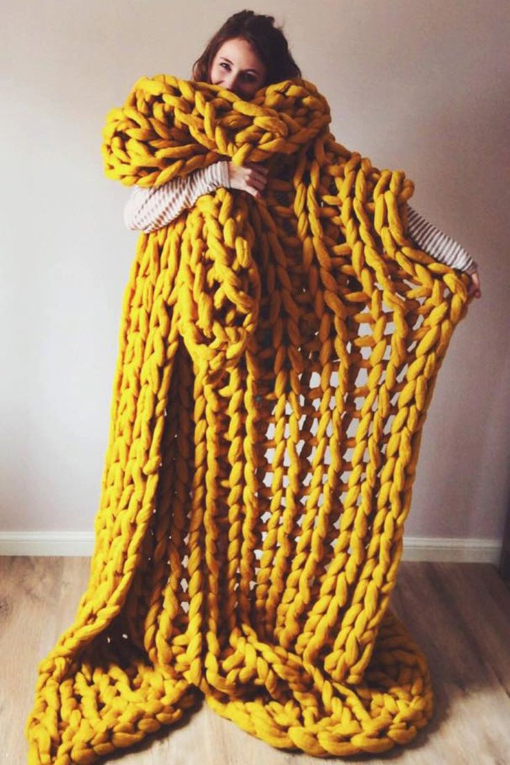 a woman is wrapped in yellow yarn