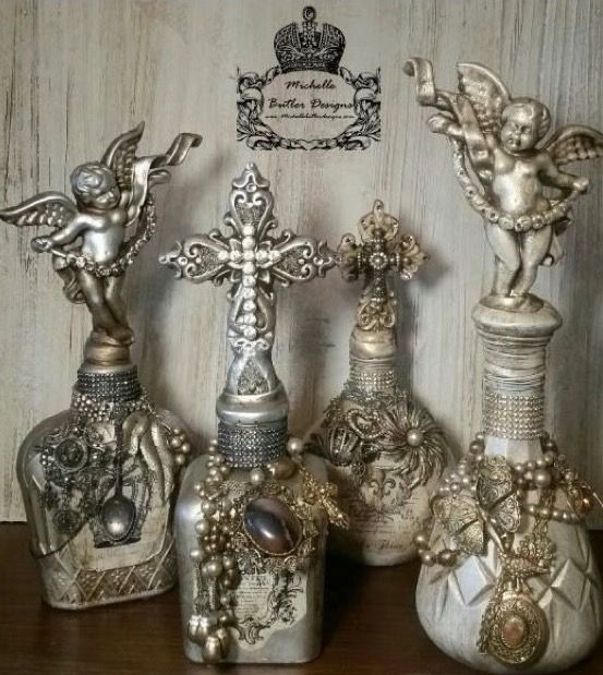 several silver vases with angels on them sitting on a table next to each other