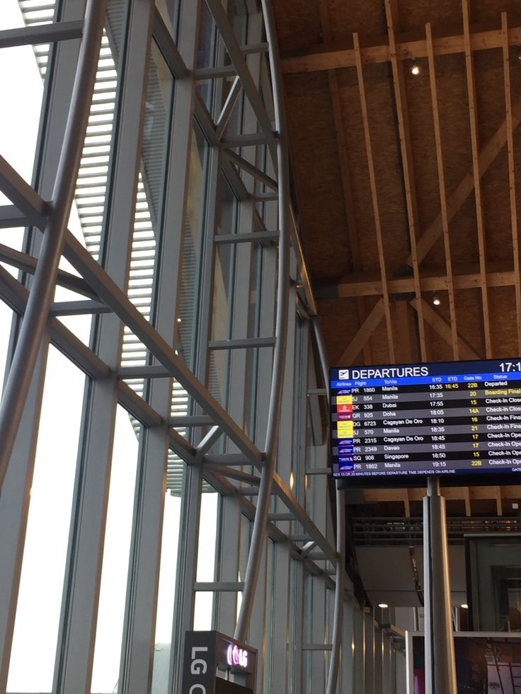 the inside of an airport with many signs