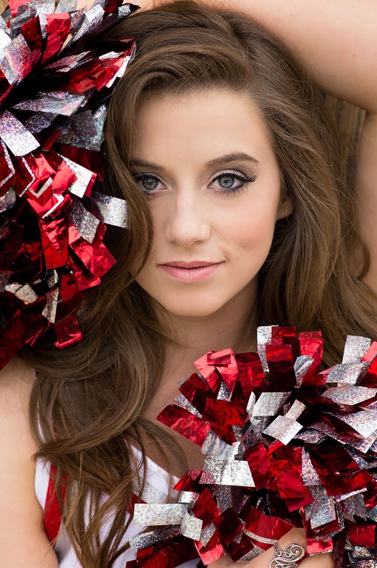 a woman with red and silver pom poms on her head