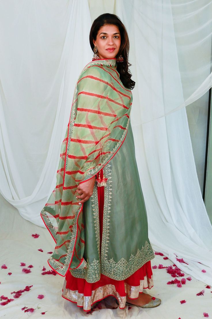 Sage green straight kurta in organza base with gota hand embroidery. Paired with red anarkali in chanderi base and an leheriya organza dupatta.
Components: 3
Pattern: Embroidered
Type Of Work: Floral
Neckline: Notched
Sleeve Type: Full
Fabric: Organza, Chanderi, Lining: Shantoon
Color: Green
Other Details: 
Side slits
Sheer dupatta
Side tassels
Occasion: Wedding - Aza Fashions Silk Kurtis, Red Anarkali, Sheer Dupatta, Bridal Mehendi Designs Hands, Indian Outfits Lehenga, Embroidered Wedding Dress, Dresses Traditional, Anarkali Dress Pattern, Kurta Set For Women