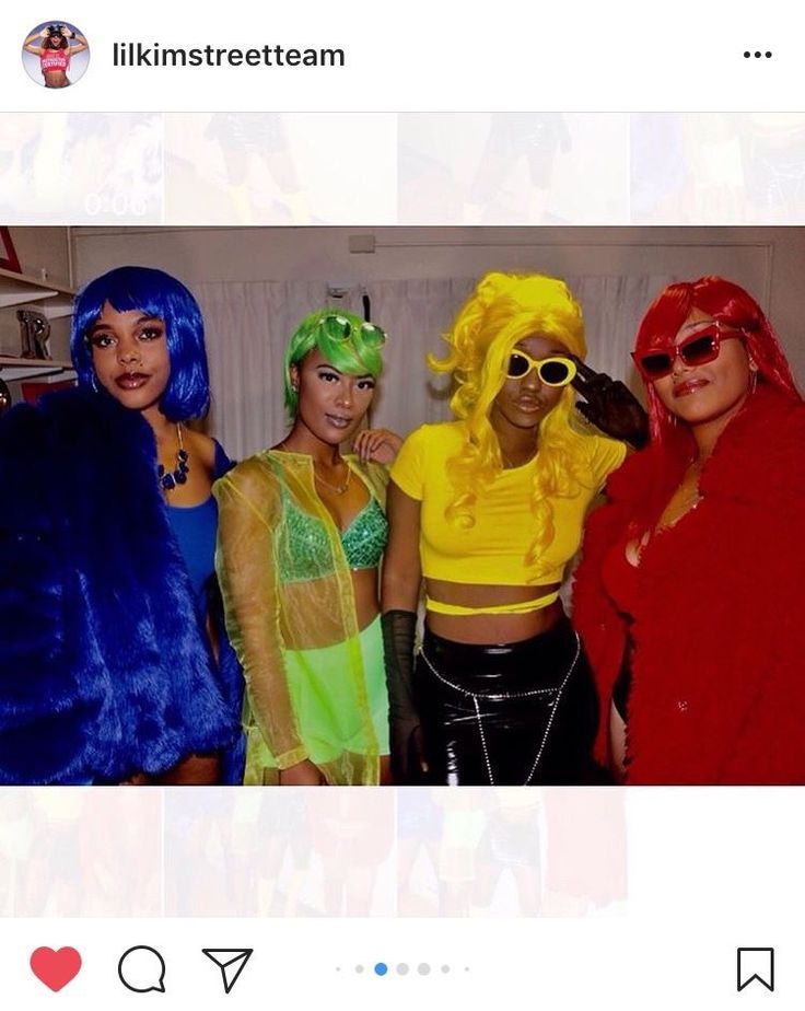 four women dressed up in costumes and wigs posing for a photo on instagram