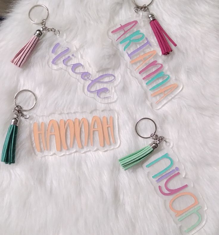 four keychains with the words hawaii, hawaii and hawaii written in different colors