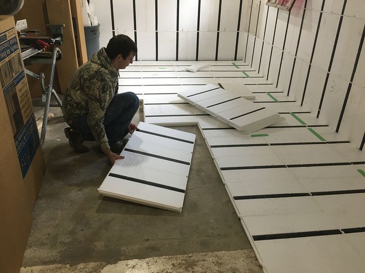 a man kneeling down next to some white boards