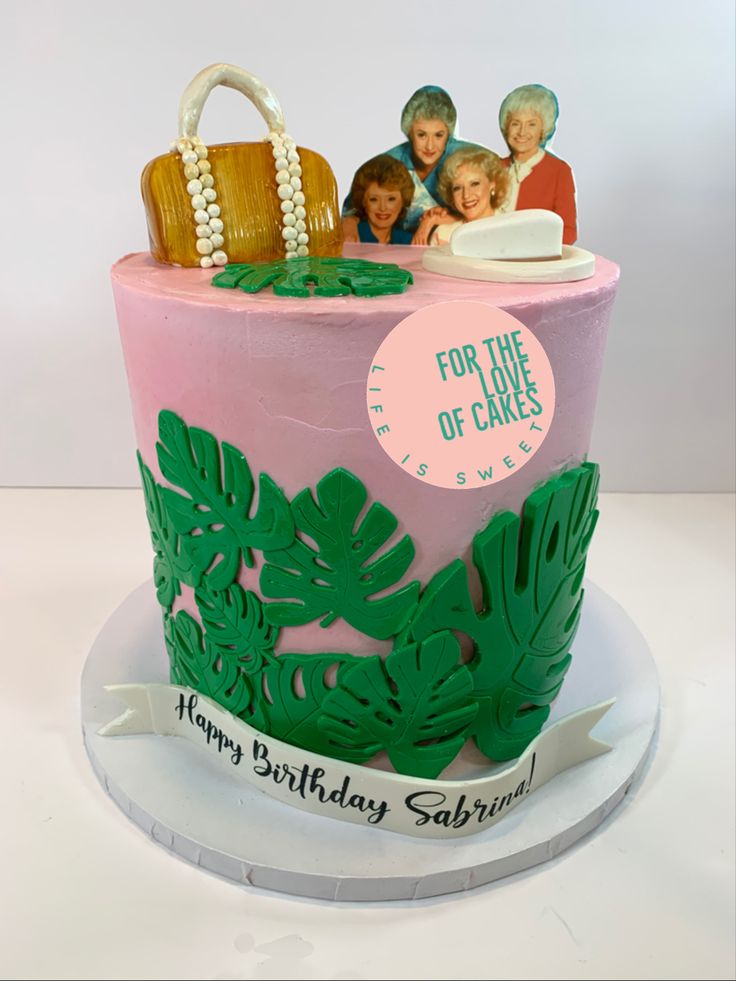 a birthday cake decorated with palm leaves and purses