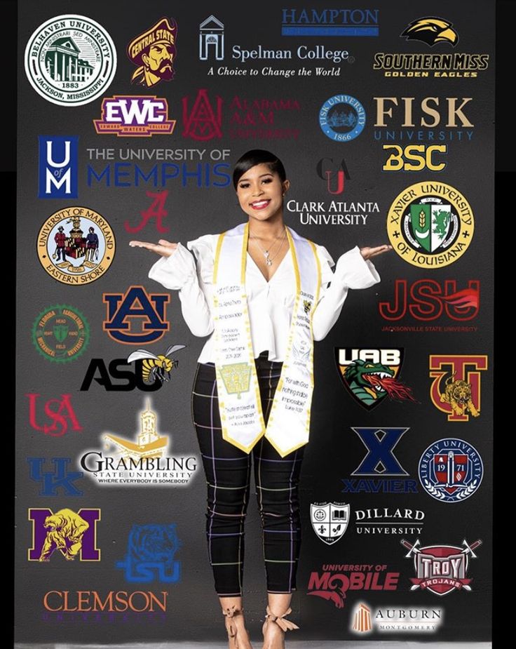 a woman is standing in front of a wall with many different logos and symbols on it