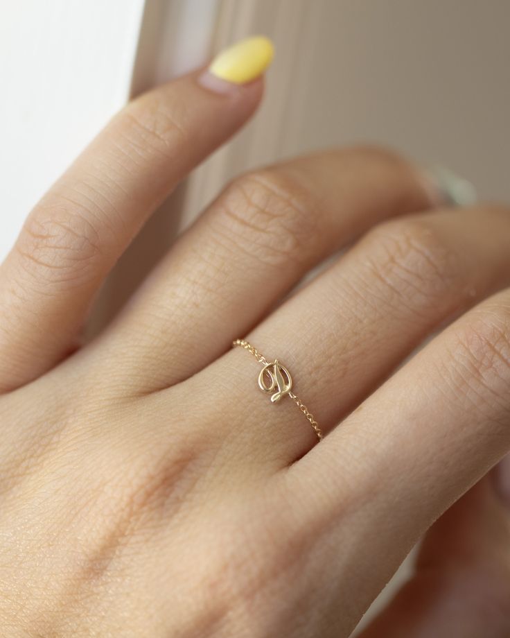 Dainty 14K Initial Letter Ring: Barely there ring in 14k Gold with a small script Letter  Modern and timeless Super Dainty Link Chain Ring Simple, minimalist everyday Alphabet Initial Ring - Perfect as a stacking ring or by itself. Each initial measures approx. 4.8mm Available in 14K Yellow Gold or 14K White Gold SIZE: US4.5 - 10 Letter: A-Z or an heart charm * Leave us your initial in the comment box at checkout. # Personalized ring Statement rings meaningful gift mom ring chain ring initial chain alphabet letter name ring solid gold ring dainty ring gold chain rings statment ring cuban link chain 14K gold everyday ring jewelry rings ■ SHIPPING UPGRADES You can find shipping upgrades options in the drop bar menu when you check out. * Within the U.S Regular First-class : 2-6 business days Elegant Small Gold Initial Ring, Gold Dainty Initial Ring With Simple Design, Delicate Gold Initial Ring With Simple Design, Dainty Gold Initial Ring With Simple Design, Dainty Yellow Gold Initial Ring For Everyday, Dainty Yellow Gold Initial Ring With Simple Design, Gold Dainty Initial Ring, Delicate Gold Initial Promise Ring, Dainty Tiny Initial Ring In 14k Gold