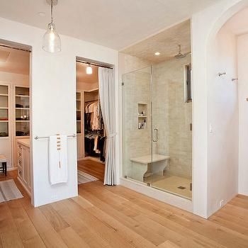 an empty room with wood floors and white walls, including a walk - in shower