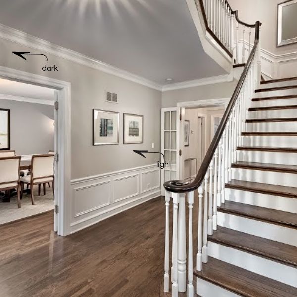 a staircase leading up to a dining room and living room in a house with hardwood floors