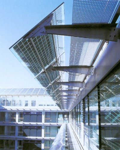 the walkway is lined with glass and steel