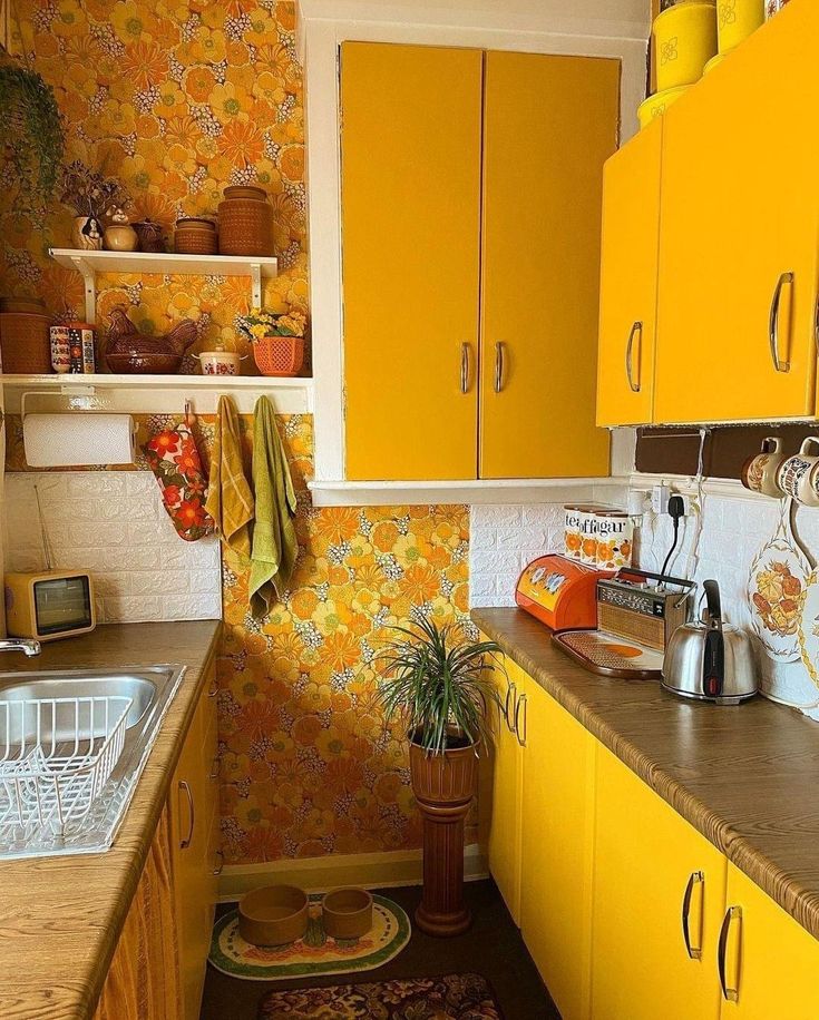 a kitchen with yellow cupboards and an area rug on the floor next to the sink