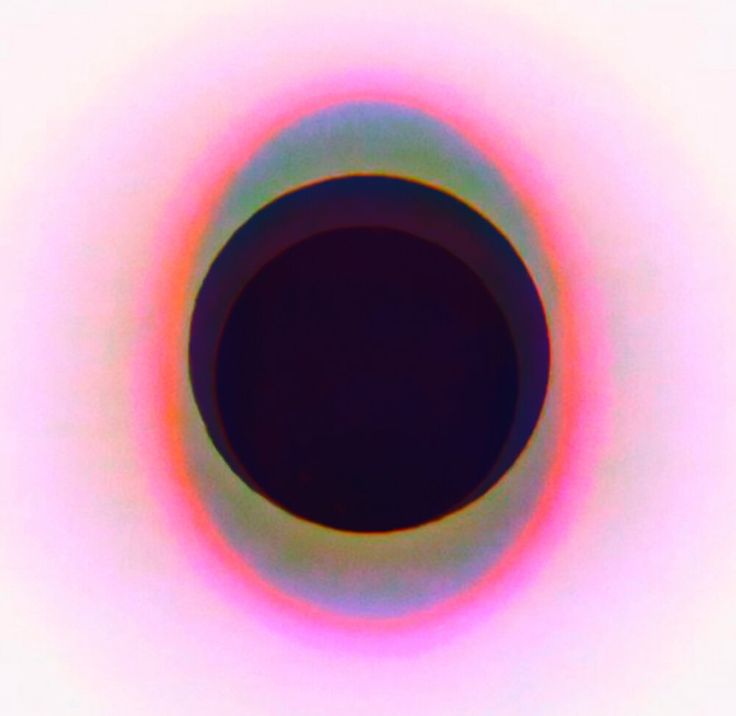 an image of a black hole in the middle of a white background with red and blue colors