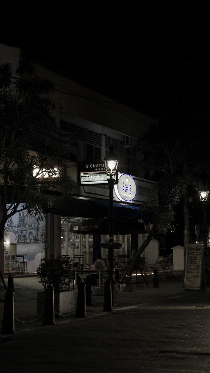 a person walking down the street at night