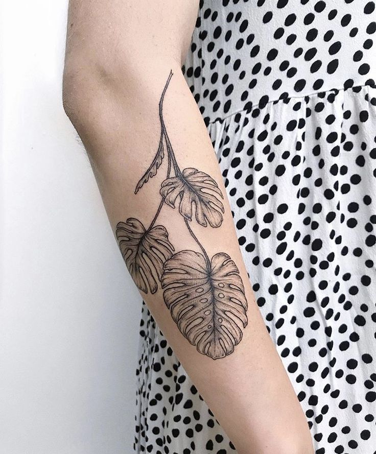 a woman with a tattoo on her arm