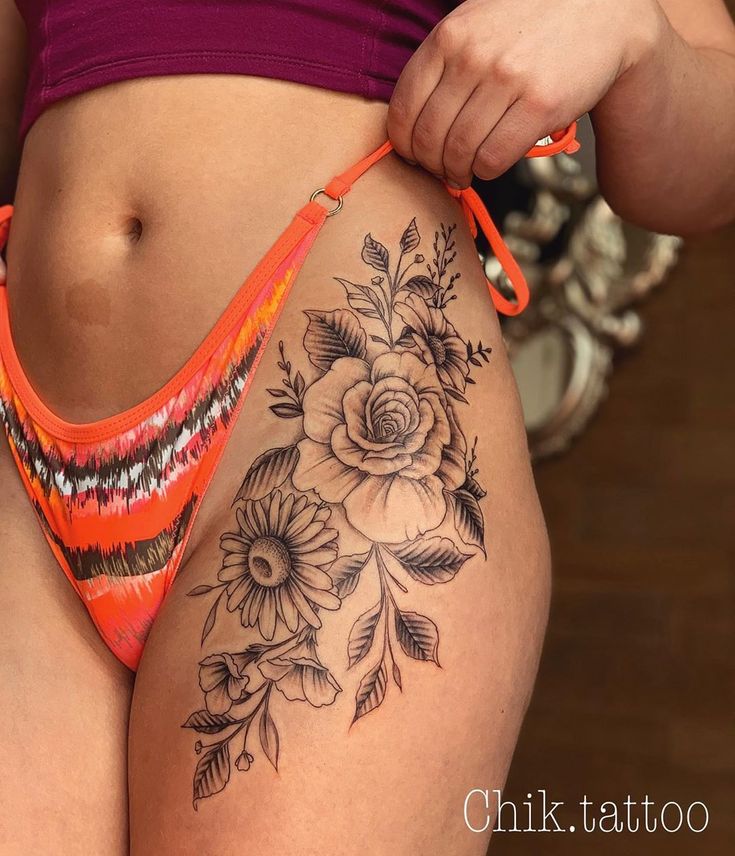 a woman with a flower tattoo on her stomach