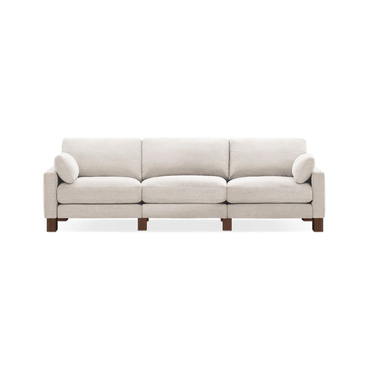 a white couch sitting on top of a wooden frame