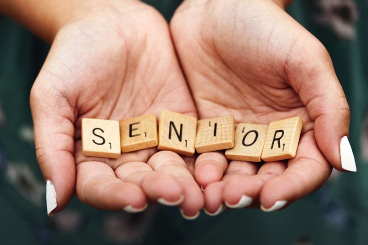 the word senior spelled with scrabbles in two hands