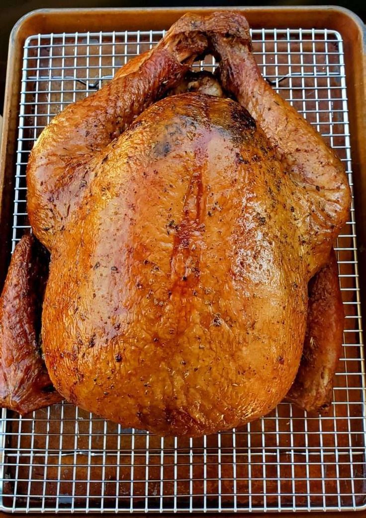 a roasted turkey on a grill with the words pellet grill smoked turkey above it