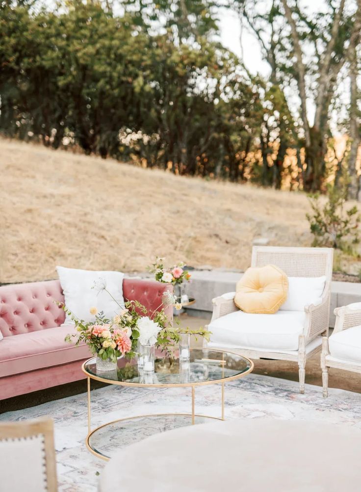 a living room filled with furniture and flowers on top of a carpeted floor covered in grass