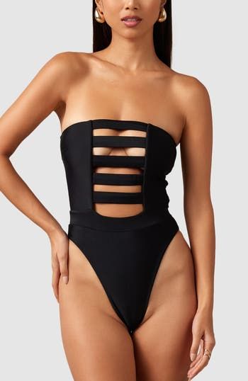 This one-piece is the perfect combination of classy and sexy. Boning and silicone elastic keep this strapless one-piece up and in place so you feel comfortable and secure. Ultra soft material, strapless, double lined Brazilian bottom coverage High cut at hips elongate the legs Elastic in waistband cinches in waist Strapless Nylon Tube Top For Night Out, Black Strapless Tube Top For Poolside, Strapless Stretch Swimwear For Club, Strapless Party Tube Top With Lined Body, Strapless Lined Tube Top For Party, Modern Black Swimwear For Party, Bandeau Swimwear With Lined Body For Party, Strapless Lined Body Swimwear For Party, Stretch Strapless Jumpsuit For Beach