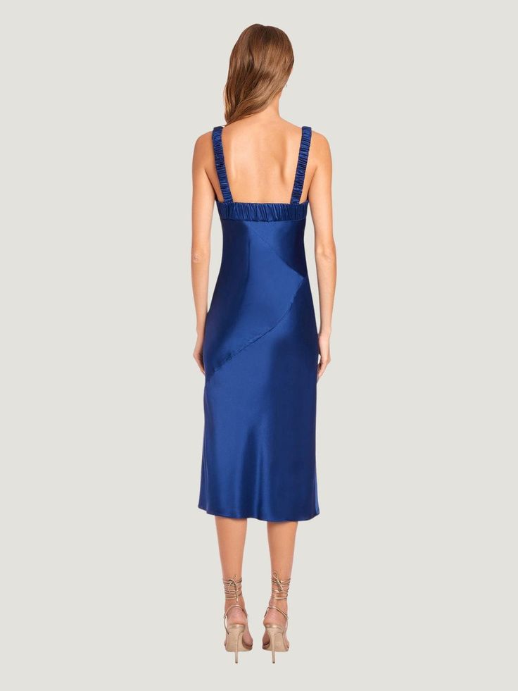 a woman in a blue dress back view