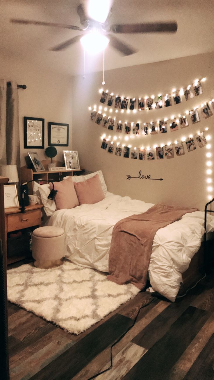 a bedroom decorated with lights and pictures on the wall