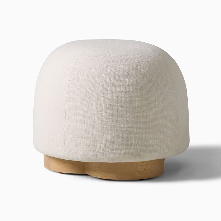 a white ottoman sitting on top of a wooden base